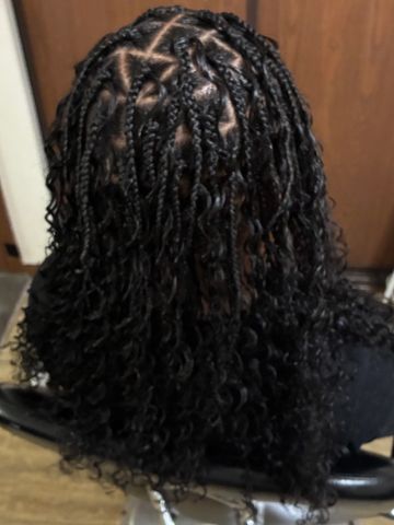 Hairstyle with cornrows and loose curls at the back.