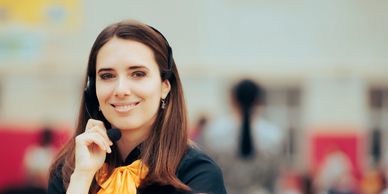 Mujer sonriendo con audífonos y ropa formal.