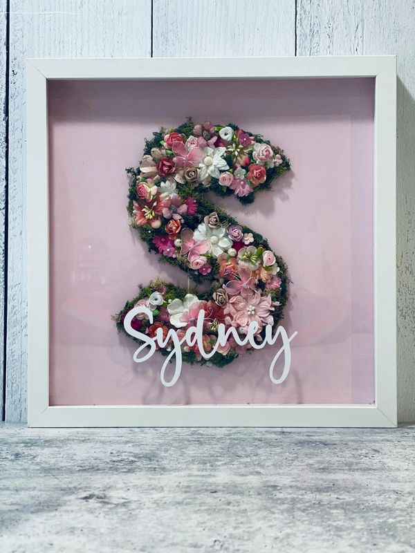 Pink flower and moss letter S in white frame 