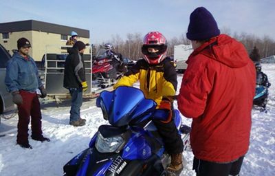 Kids on snowmobiles getting ready for safety test.