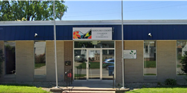 Facade of the Sandusky County Chamber of Commerce building on a sunny day.