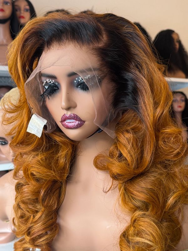 Mannequin with voluminous curly ombre wig and glittery makeup.