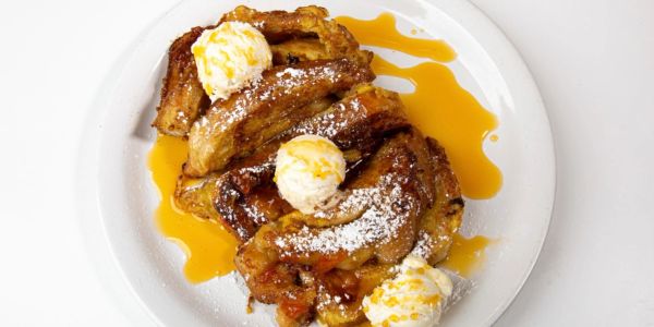 French toast with whipped cream and syrup.