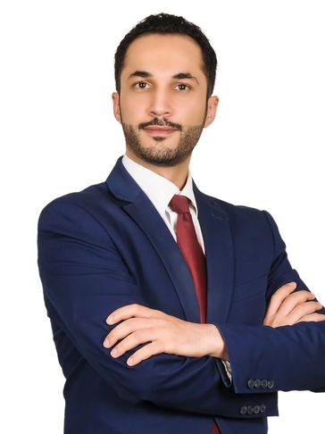 Man in a suit with arms crossed.