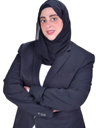 Confident woman in black hijab and blazer.