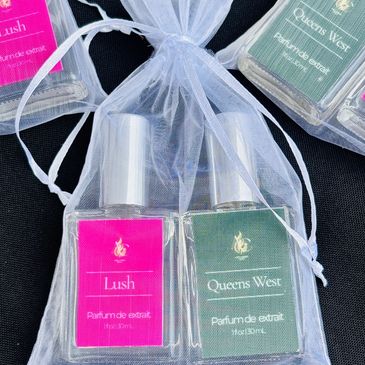 Two perfume bottles, Lush and Queens West, in a sheer white pouch.