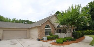 A single-story house with a garage and landscaped front yard.