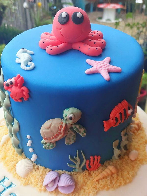 Ocean-themed cake with cute sea creatures.