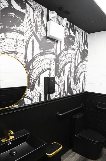 Sleek vessel sink in black with golden hardware
