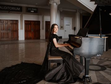 senior girl playing grand piano