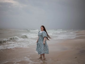 senior girl standing on beach