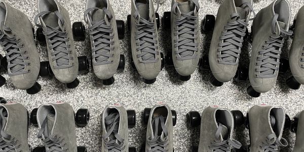 A group of rental roller skates of various sizes.