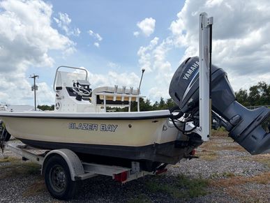 Boat named Blazer Bay on a trailer with a Yamaha motor.