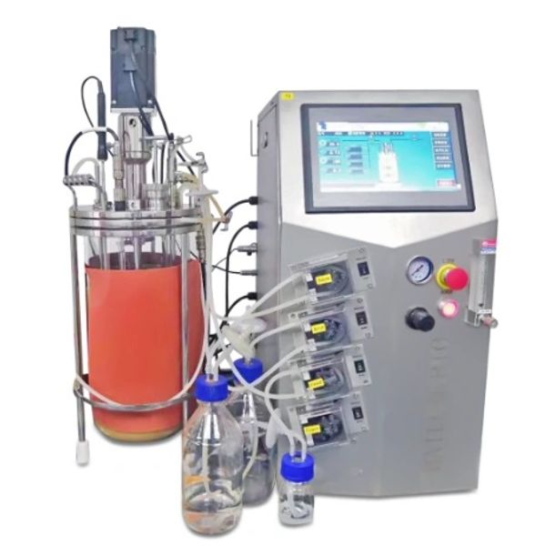 Bioreactor setup with control panel and fluid bottles.