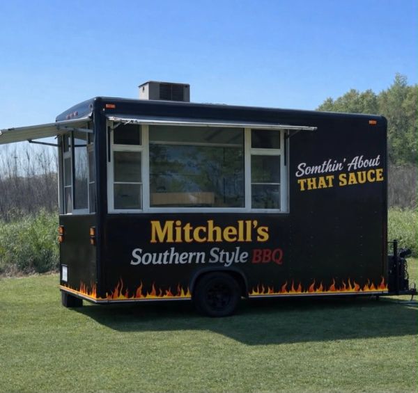Mitchell's Southern Style BBQ food truck with flame design and slogan.