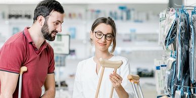 Man getting fitted with crutches