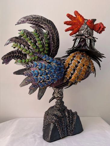 Colorful rooster sculpture with intricate feather details.