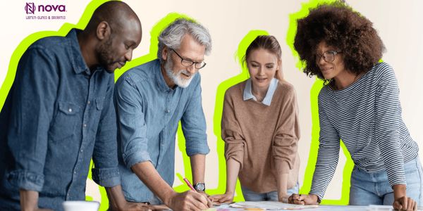 Diverse team collaborating on a project around a table with documents and sticky notes.