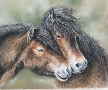 Two horses nuzzling affectionately with flowing manes.