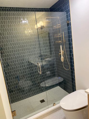 Frameless shower enclosure 