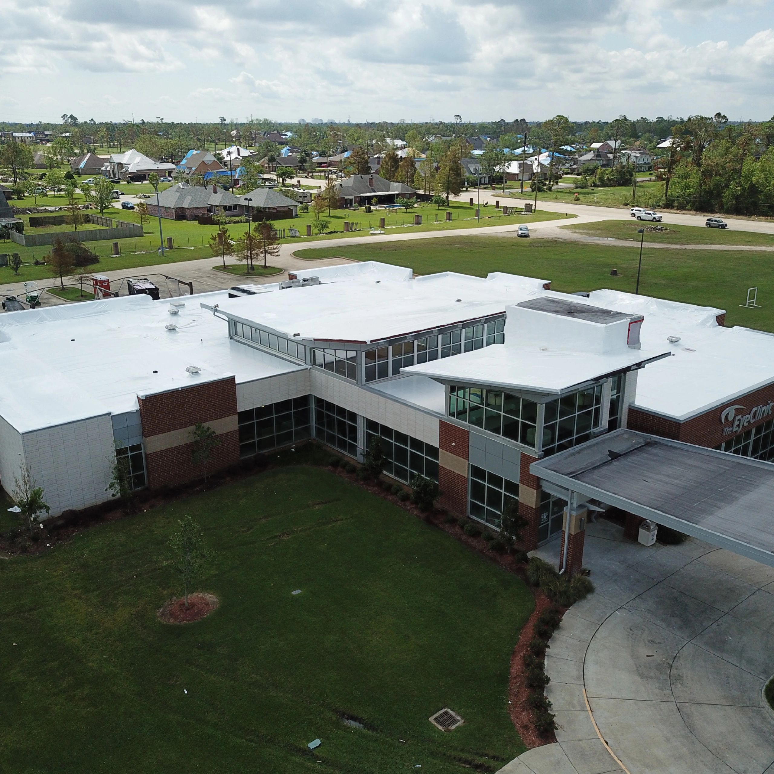 shrink wrap roof tarp to cover commercial roof damage after Hurricane wind damage