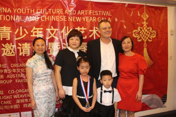 Group photo at China Youth Culture and Art Festival with adults and children.