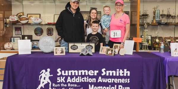 Group at Summer Smith 5K Addiction Awareness Memorial Run table.