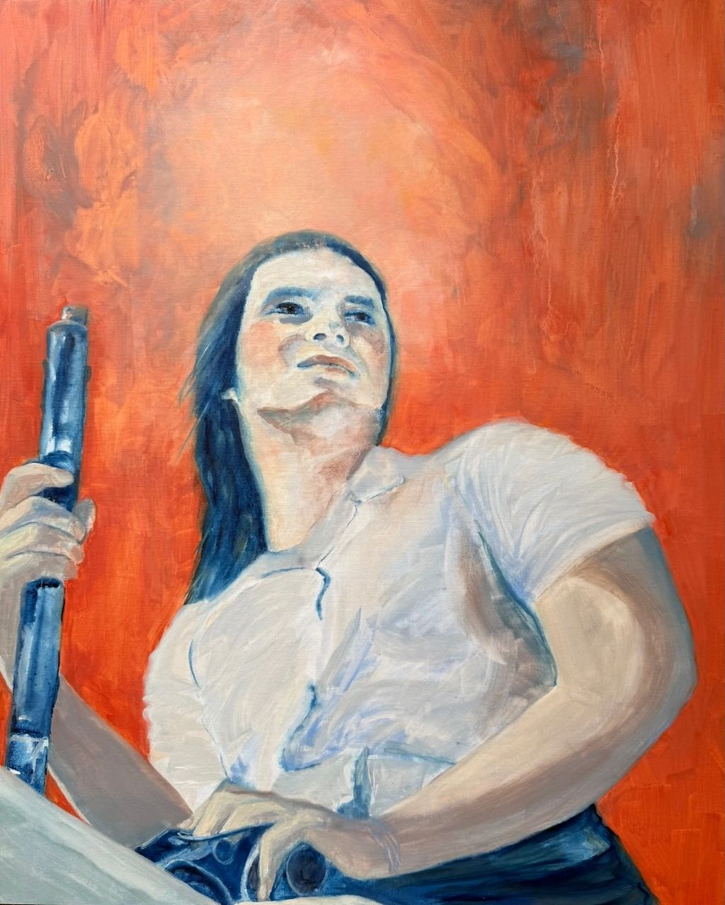 Portrait of a confident woman holding a blue object against an orange background.