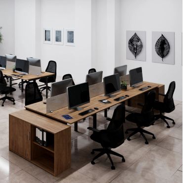 Modern office workspace with wooden desks and black chairs.