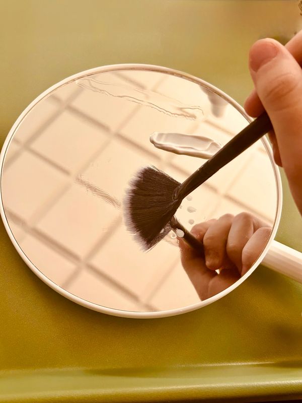 facial products, smoothed out with a facial brush