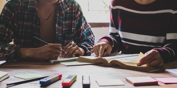 Asian young man and woman sitting pointing studying examining, Tutor books with friends