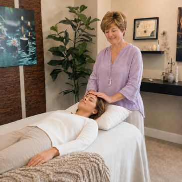 Woman receiving a head massage in a cozy room.