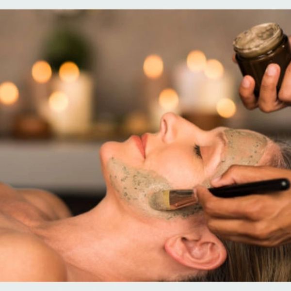 Woman receiving a facial mask treatment.