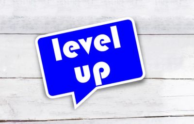 Blue speech bubble with 'level up' text on wooden background.