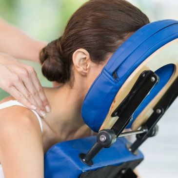Woman receiving a shoulder massage on a massage chair.