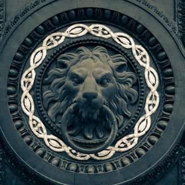 Black and gold lion-themed door knocker in Brevard County