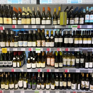 Shelves stocked with various wines and champagnes in a store.