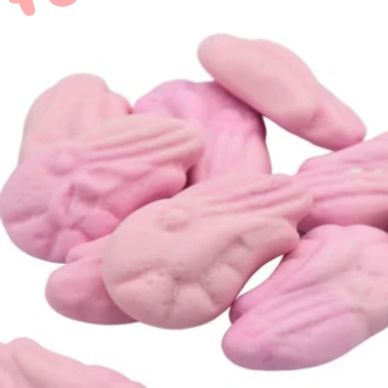 Pink foam shrimp candy pieces on a white background.