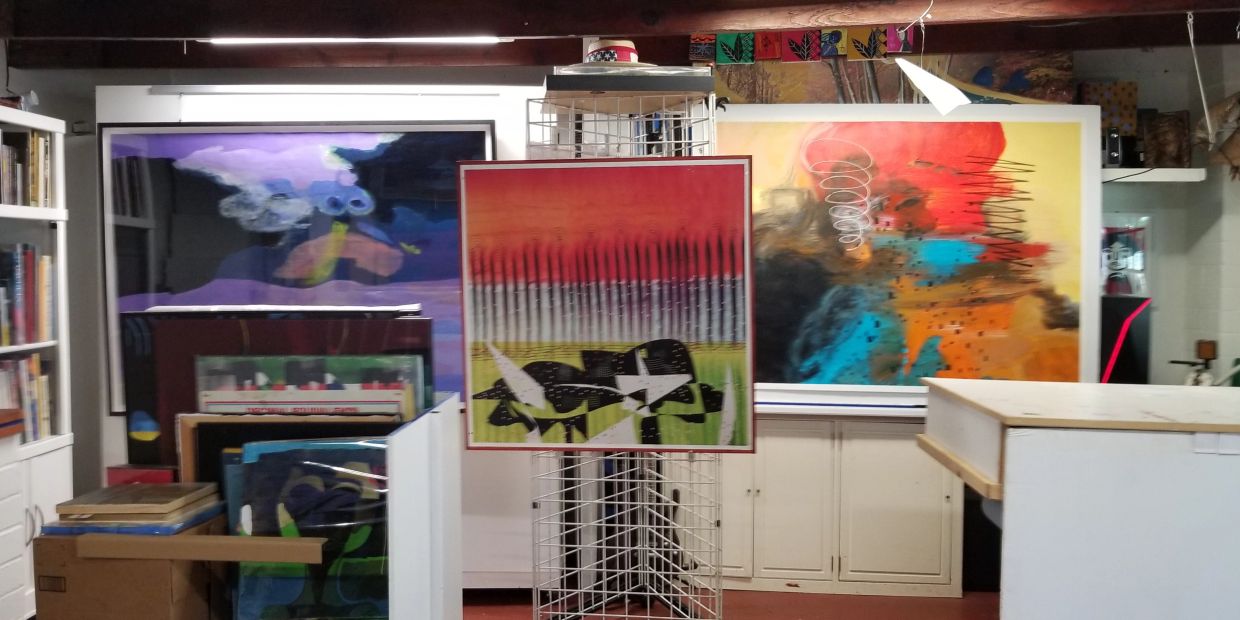 Abstract paintings displayed in an art studio.