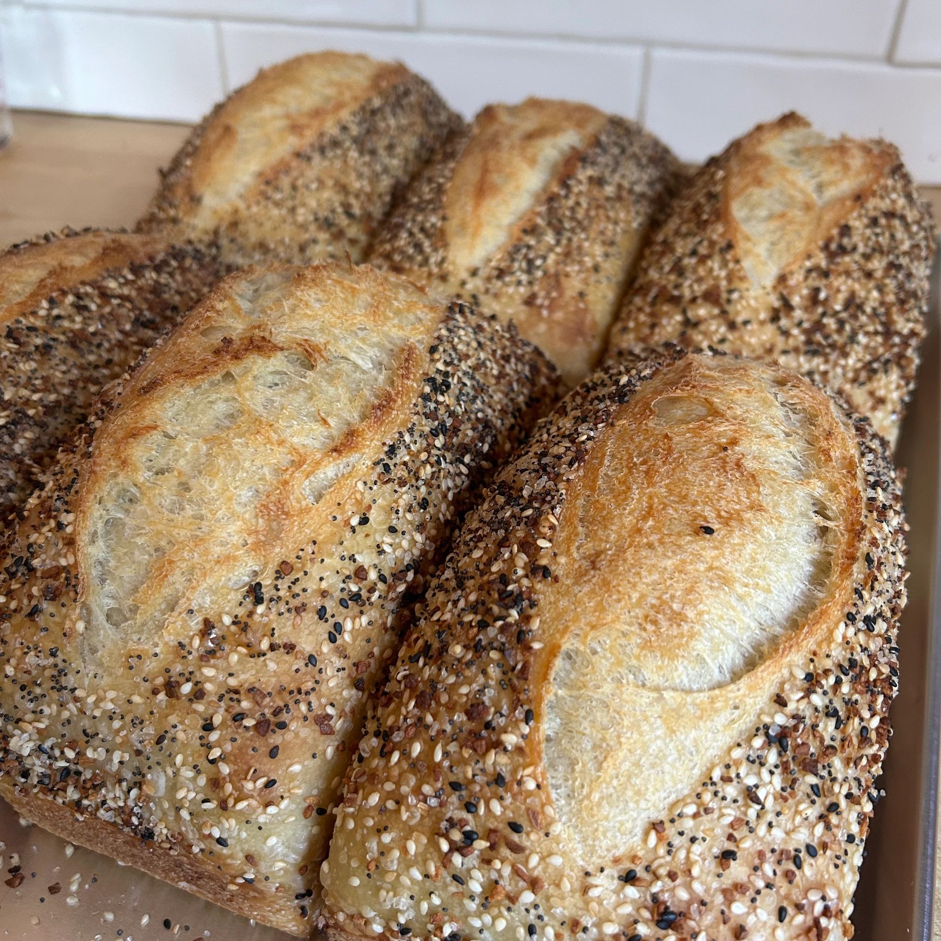 Freshly baked seeded breads with golden crusts.