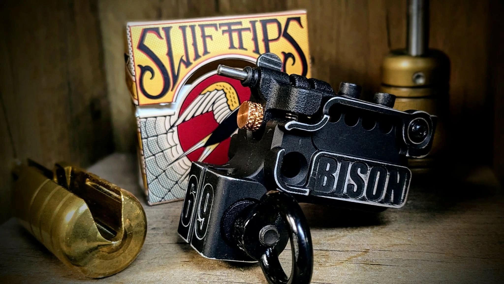 Close-up of a Bison tattoo machine with Swift Tips tattoo needles.