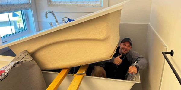 GSO Plumber installing a bathtub