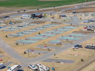 Aerial view of an RV park with parked trailers and empty spaces.