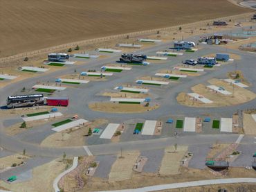A large RV park with numerous parking spots and several parked RVs.