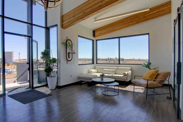Modern living room with large windows and minimalist furniture.