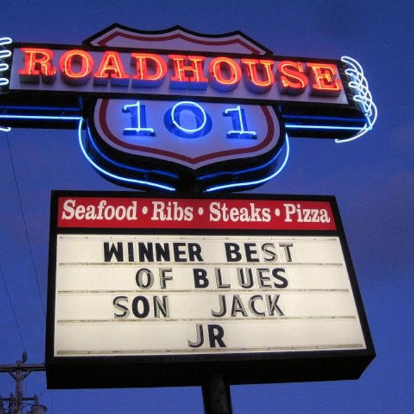 Neon sign for Roadhouse 101 with contest winner announcement.