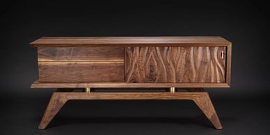 Modern wooden cabinet with carved doors.