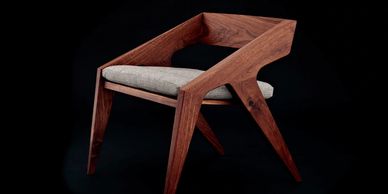 Modern wooden chair with upholstered seat.