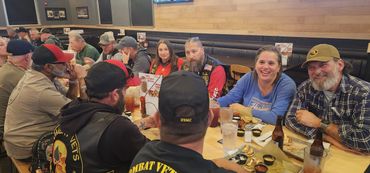 Group of people enjoying a meal together at a restaurant.