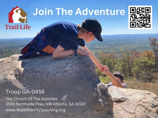 Boy helps another climb a rock, promoting outdoor adventure with Trail Life.